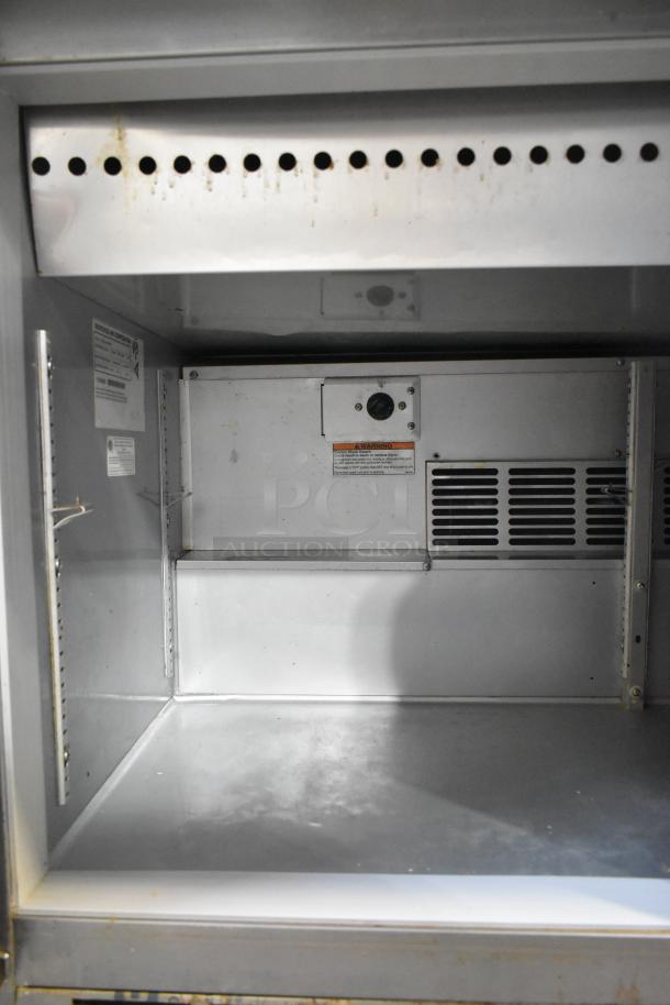 Beverage Air SPE48-18M-HMP stainless steel interior, showing refrigeration components and warning labels. Clean condition.