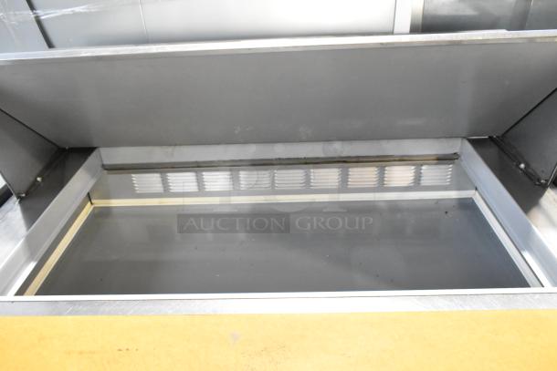 Beverage Air SPE48-18M-HMP stainless steel sandwich prep table with mega top, clean interior, on commercial casters.