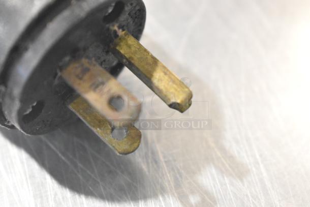 Close-up of a power plug for a Star Holman Conveyor Toaster Oven, 120 volts, 1 phase, showing wear on metallic prongs.