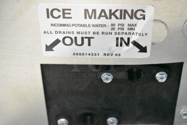 Manitowoc IYT0750A-261 Indigo NXT ice machine tag showing water pressure info, with directional arrows and serial number.