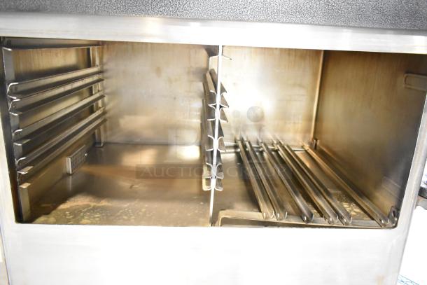 Cleveland PGM3002 stainless steel 16-pan natural gas pressure steamer with boiler base, 300,000 BTU, interior view.