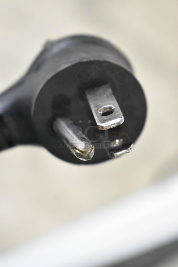 Close-up of a power plug showing a three-prong design, associated with the True TSCI-600R-G-PH cooler merchandiser.
