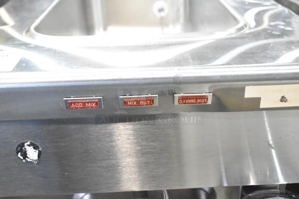 Stainless steel Taylor 340D-27 beverage machine panel with buttons labeled "ADD MIX," "MIX OUT," and "CLEANING REQD."