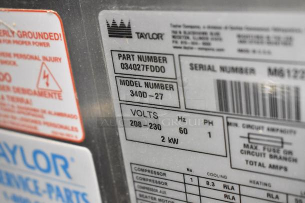 Taylor 340D-27 stainless steel frozen beverage machine label; 208-230V, 1 phase, model and part numbers visible.