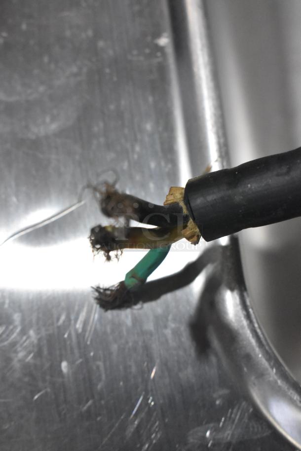 Damaged power cable of a Taylor 340D-27 commercial frozen beverage machine, showing exposed wires and wear.