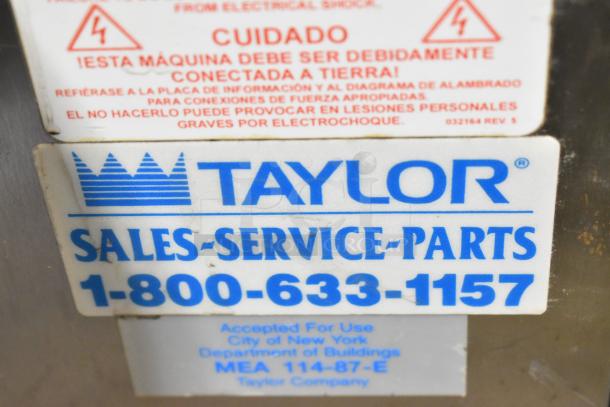 Taylor 340-27 stainless steel commercial countertop frozen beverage machine with drink mixer. Includes contact info for service.