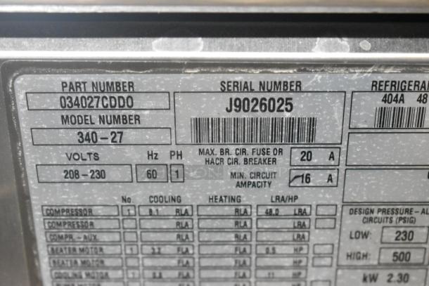 Label on a Taylor 340-27 stainless steel beverage machine, showing part and serial numbers, voltage, and capacity details.