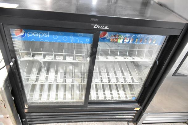 True GDM-41SL-48-HC-LD 2-door cooler merchandiser with glass doors and poly-coated racks, 115V, 1 Phase, good condition.