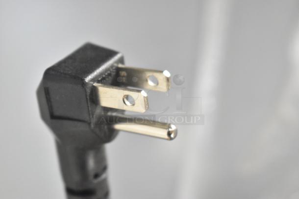 Close-up of a three-prong plug, likely part of a 2022 Blue Air BKGF49-HC commercial freezer, showing standard power connector.