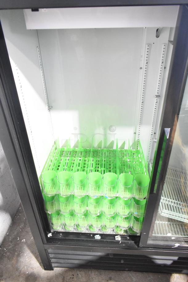 2020 True GDM-41SL-60-HC-LD commercial cooler, black frame, poly coated racks, visible green shelving, excellent condition.