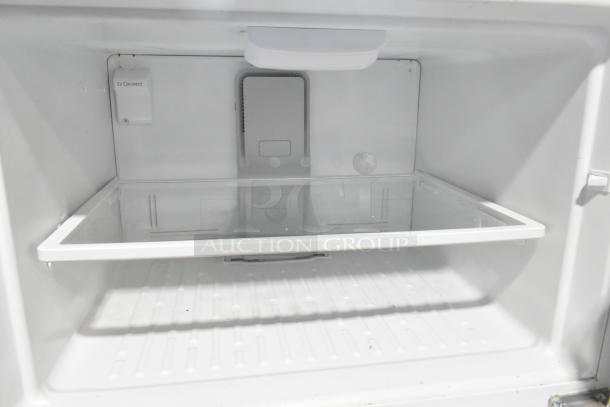 Whirlpool metal reach-in cooler with freezer, 115 volts, 1 phase. Interior features clear shelf. "Ez Connect" label visible.