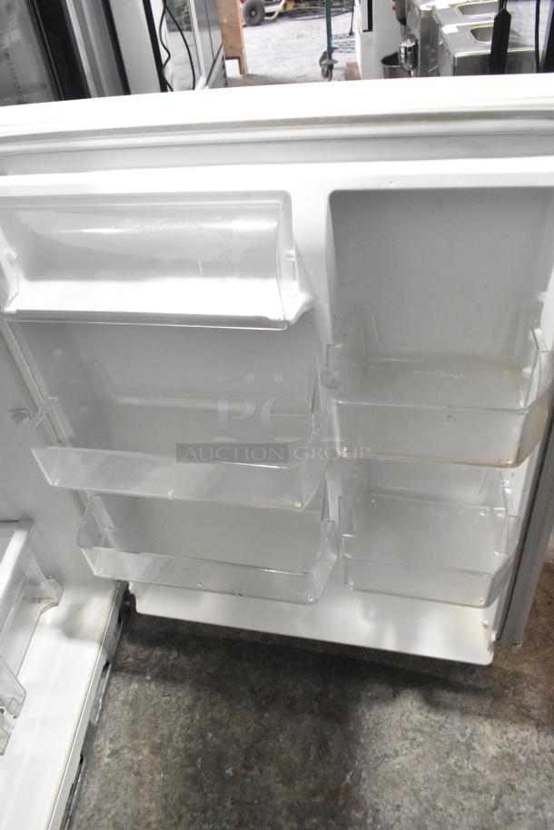 Whirlpool Metal Reach-In Cooler with Freezer, 115 Volts, 1 Phase. Interior shelves visible, in good condition.