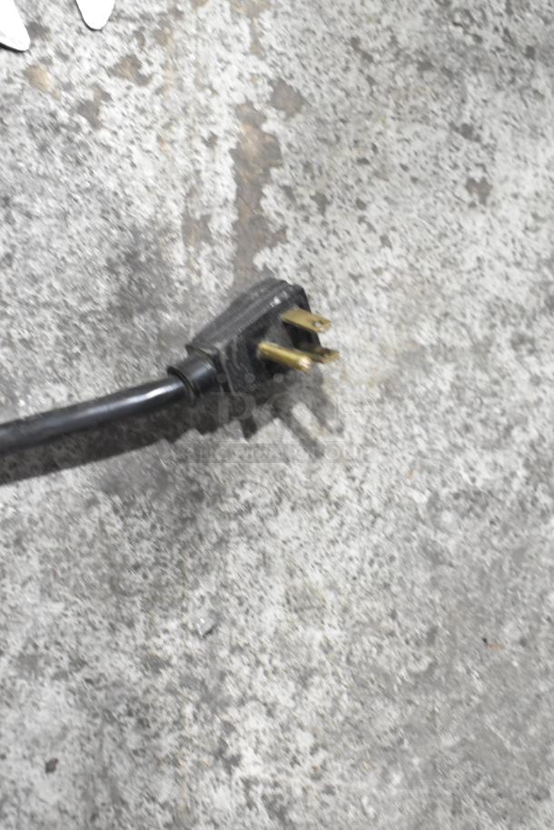 Close-up of a three-prong plug for the True GDM-12 commercial cooler, indicating 115 volts, 1 phase power requirement.