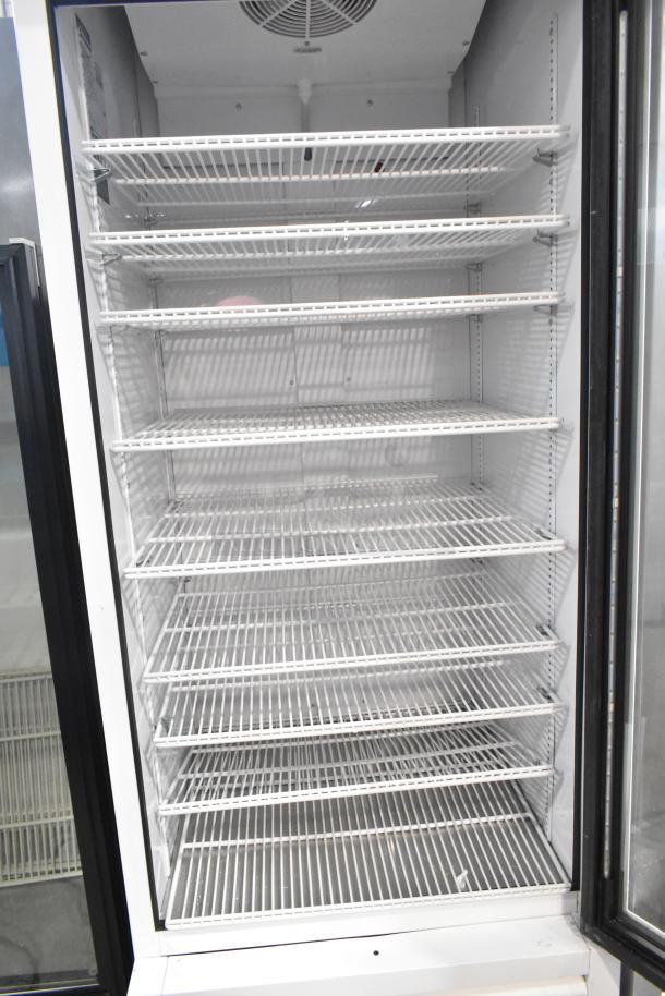 2021 True TSCI-600R-G-PH single door cooler merchandiser with poly-coated racks, in excellent condition, 115V, 1 Phase.