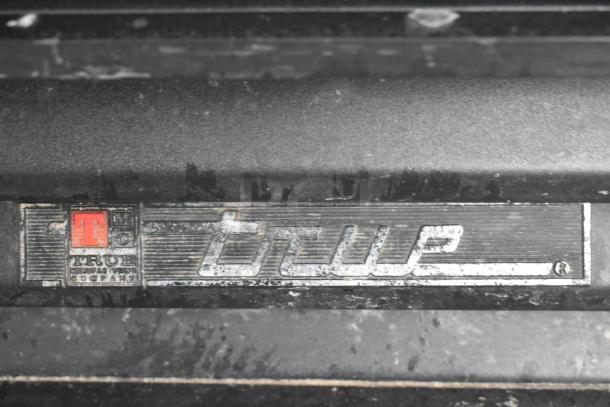 True Metal Commercial Single Door Reach In Cooler; True logo on panel; 115V, 1 Phase; metal surface with visible wear.
