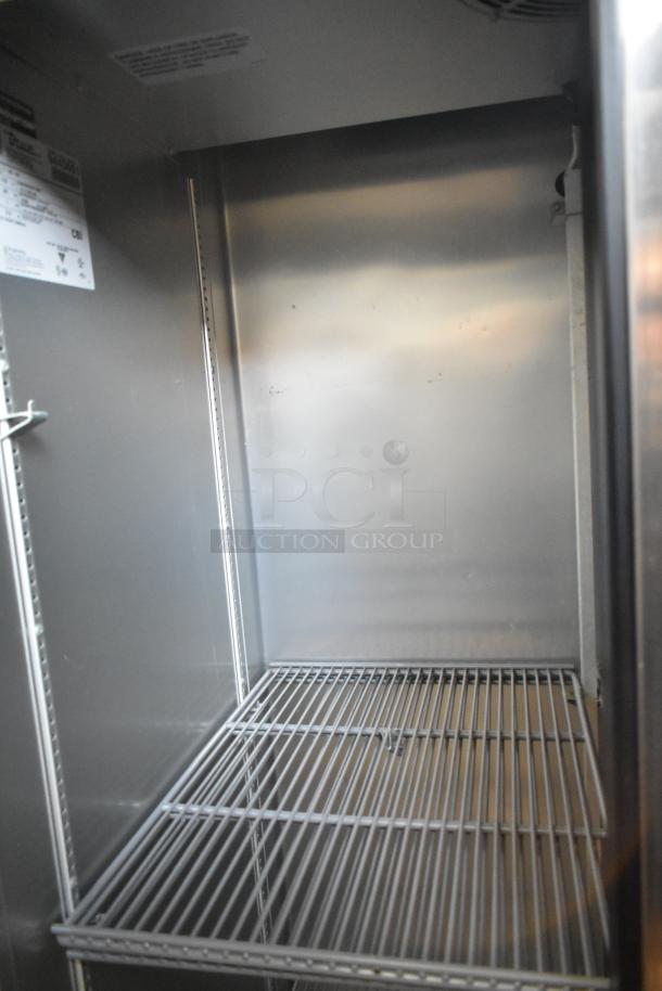 2018 True T-35-HC commercial reach-in cooler, stainless steel, dual doors, with poly-coated racks, interior view.