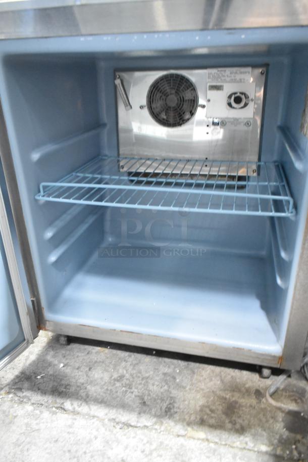 Delfield 406CA-DHL-DD1 stainless steel single door undercounter cooler on commercial casters, 115V, 1 phase, interior view.