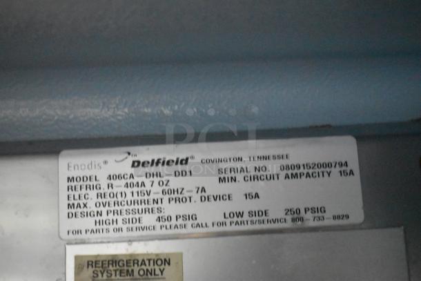 Delfield 406CA-DHL-DD1 stainless steel undercounter cooler label. Model, serial number, and electrical details shown.