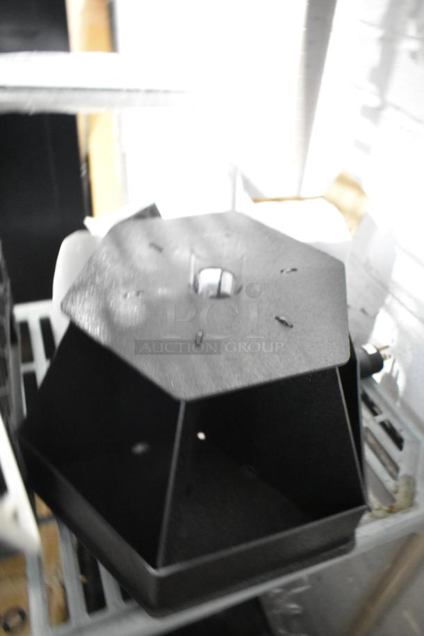 Hexagonal black metal rack, industrial finish, part of a tier lot, in good condition.