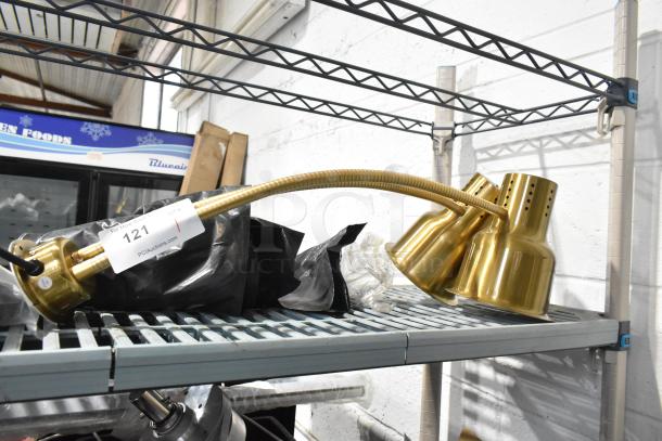 CK7413B0698 metal warming lamp with two heads, in gold finish, 120 volts, 1 phase. Item tag: lot 121 from PCL Auctions.