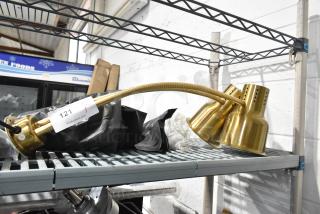 CK7413B0698 metal warming lamp with two heads, in gold finish, 120 volts, 1 phase. Item tag: lot 121 from PCL Auctions.