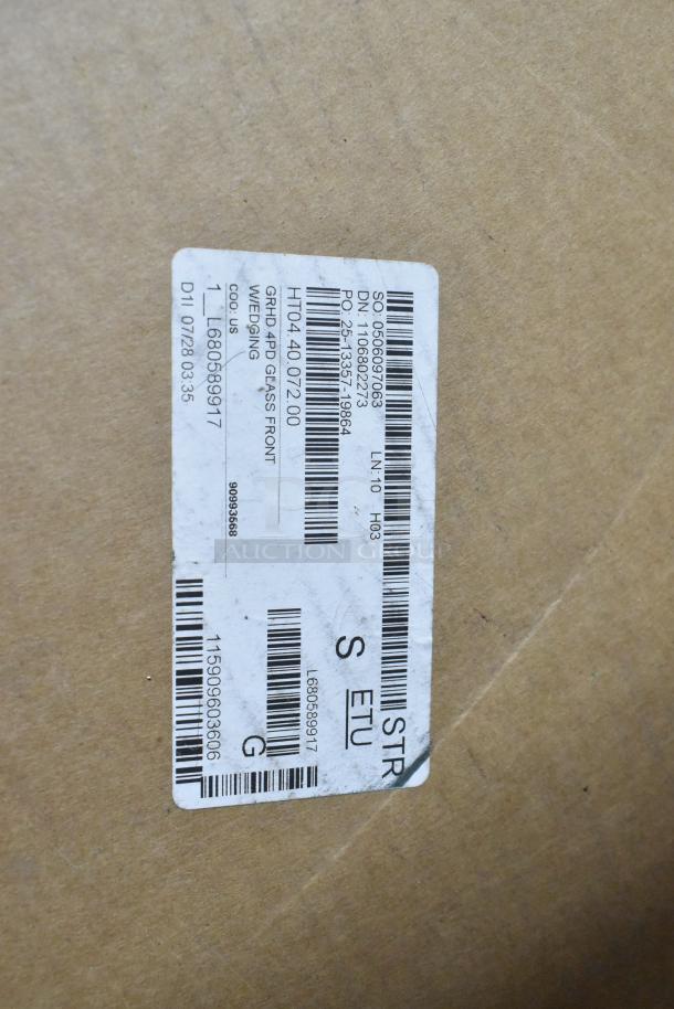 "Brand new scratch and dent PD-8 glass door in box. Shipping label with product details and codes visible on packaging."