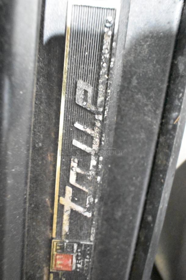 "True cooler vent cover, worn condition, black with faded branding visible on vent grid."