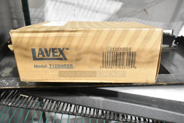 Lavex 712SNRSS box on a shelf, containing a stainless steel wall mount sanitary napkin receptacle.