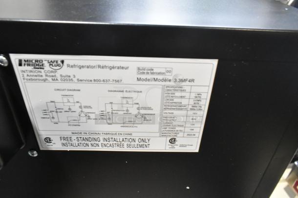 Brand new Micro Fridge 3.3MF4R metal mini fridge, 115 volts, 1 phase, with scratch and dent. Model label visible.
