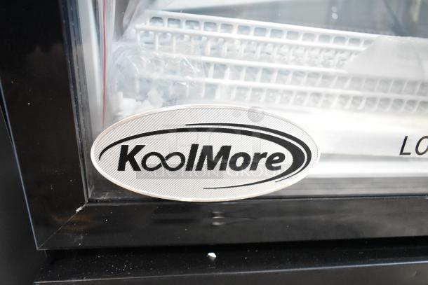 Brand new KoolMore KM-MDR-1GD-10C commercial display cooler with logo plate, metal frame, 115V, 1 phase, slight scratches.