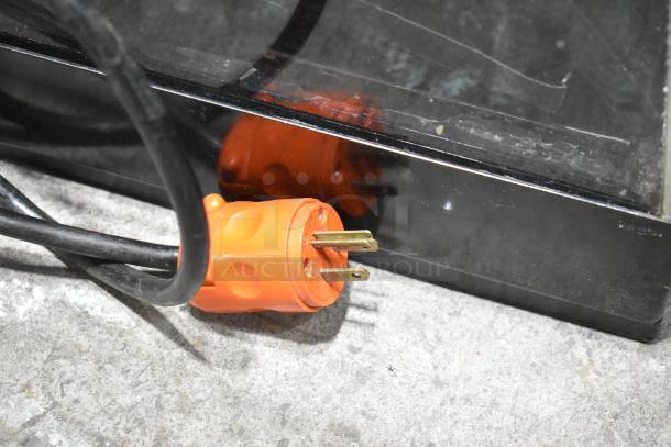 Metal countertop dry merchandiser display case with orange electrical plug, 115 volts, 1 phase. Visible minor wear.
