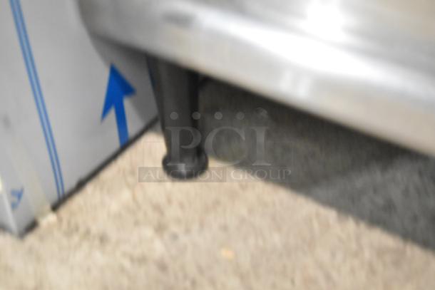 Blurry image of a Hatco stainless steel commercial countertop electric powered thermo finisher leg.