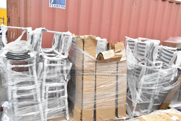 28 brand new black metal bar height ladder back chair frames, wrapped in plastic, showing minor scratches and dents.