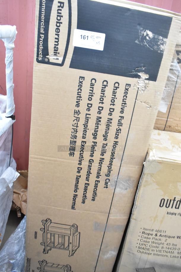 Rubbermaid housekeeping cart box with minor scratches, marked "Executive Full-Size." Outdoor Interiors chair box visible.
