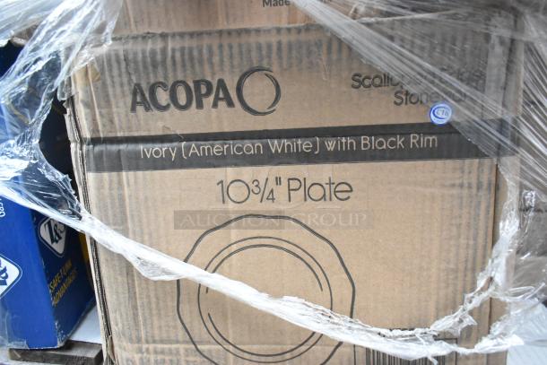 Acopa ivory plates with black rim, 10¾" size, new in original packaging, visible through plastic wrap.