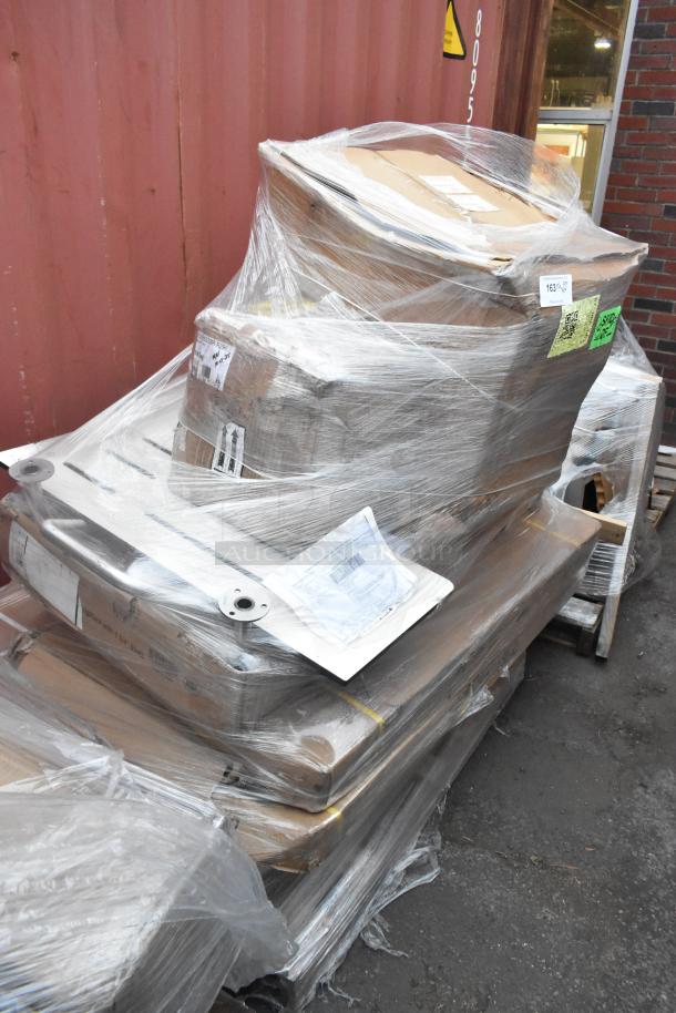 Shrink-wrapped pallet with 8 brand new scratch and dent items, including work tables and compressor, visible labels and barcodes.