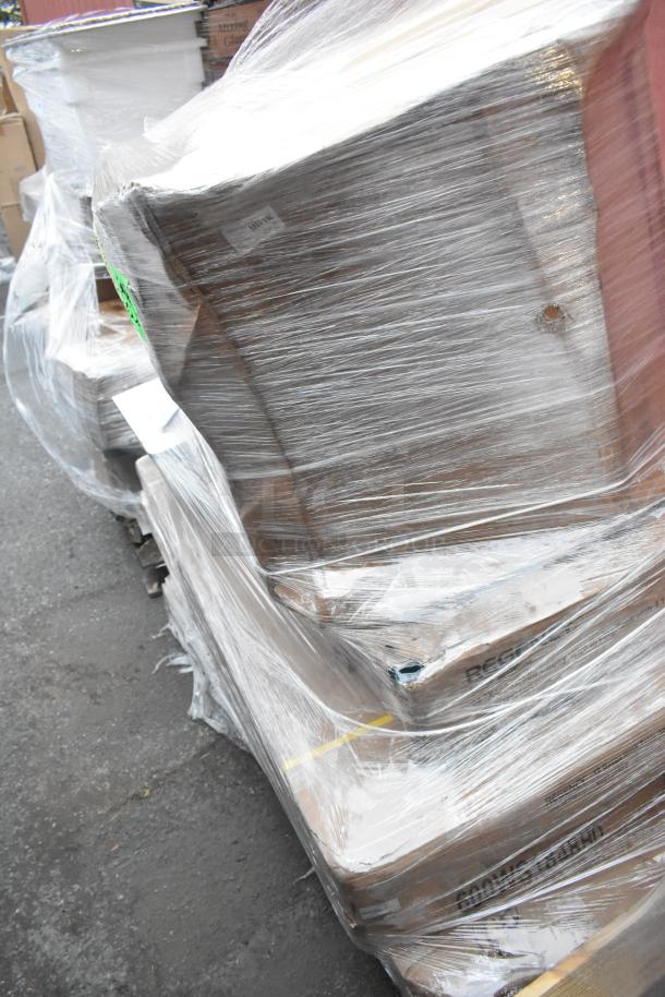 Shrink-wrapped pallet containing 8 new scratch and dent items including work tables and a compressor. Visible labels read "FRAGILE".