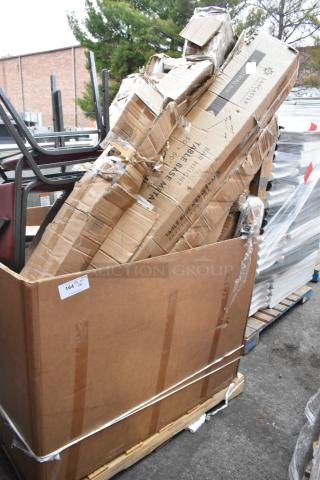 Large box of 8 brand new scratch and dent items, including chairs. Boxes visibly damaged. Label: "Table Base Material."