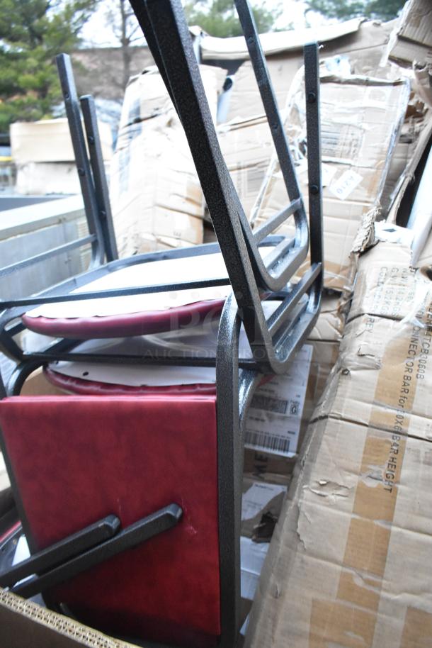 Eight new scratch and dent chairs with red padded seats, stacked in packaging. Visible boxes show slight damage.