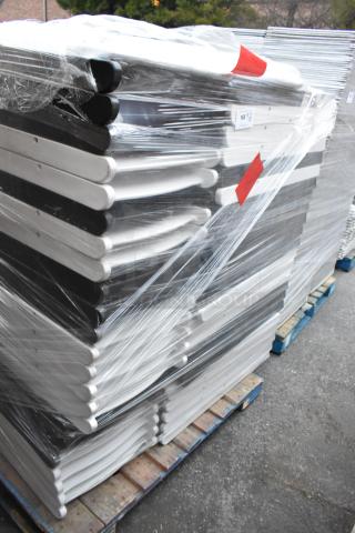 Stack of 48 black and white folding chairs wrapped in plastic on pallets, labeled for auction.