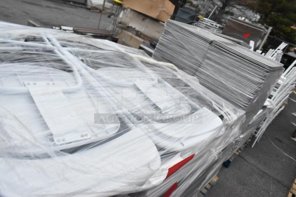 48 folding chairs wrapped in plastic, including white and black. Sold as a lot. Ideal for events or gatherings.