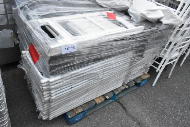 Bundle of 48 folding chairs in white and black, wrapped on pallet. Includes auction label "167," indicating quantity and lot.