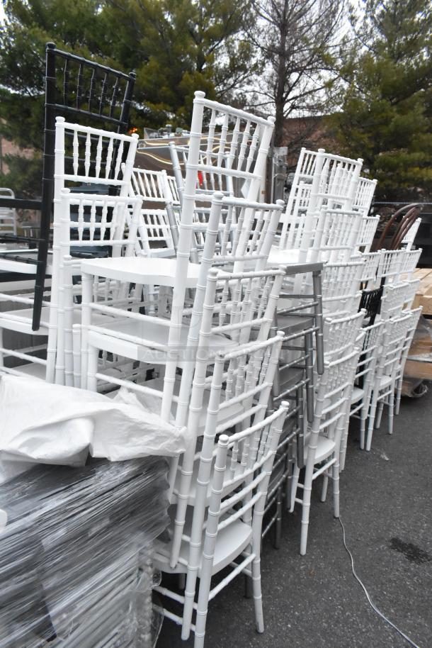 62 Chiavari stackable banquet chairs, white and black; various good condition, ideal for events.