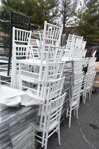 62 Chiavari stackable banquet chairs, white and black; various good condition, ideal for events.