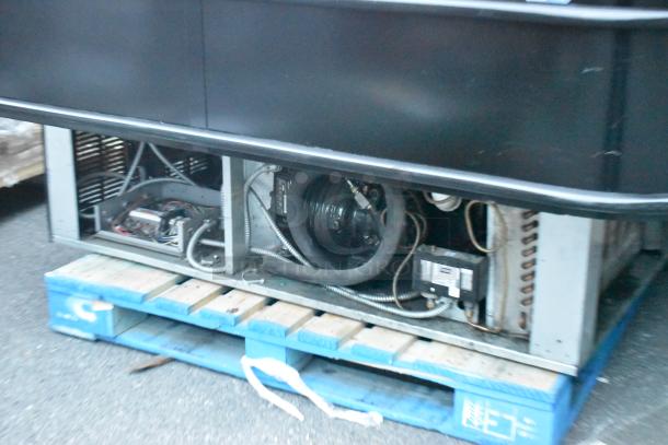 Black Metal Island Style Grab N Go Merchandiser on a pallet, showing open cooling system. Suitable for store displays.