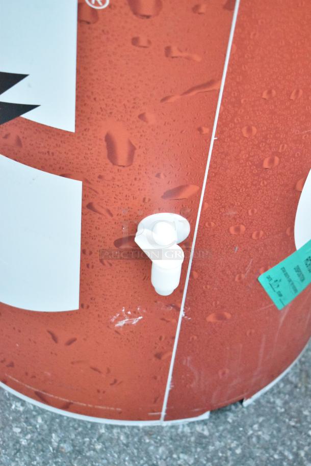 Poly Portable Bottle Cooler with red exterior, featuring a white spout for dispensing. Visible label with pricing info.