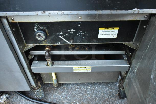 Giles EOF-24 stainless steel commercial electric fryer with 3 bays, dumping station, visible wear, caution labels shown.