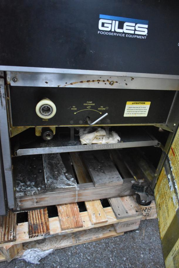 Giles EOF-24 stainless steel commercial electric 3-bay deep fryer with dumping station, shown on casters, some rust visible.