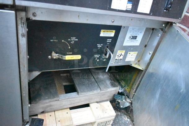 Giles EOF-24 Stainless Steel 3 Bay Deep Fat Fryer with dumping station on casters. Features control panel with caution and operational labels, 480V, 3 phase.