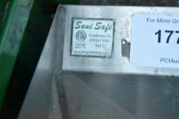 Stainless steel single bay sink with faucet, handles, side splash guards. "Sani Safe" label, conforms to ANSI/NSF Std 2.